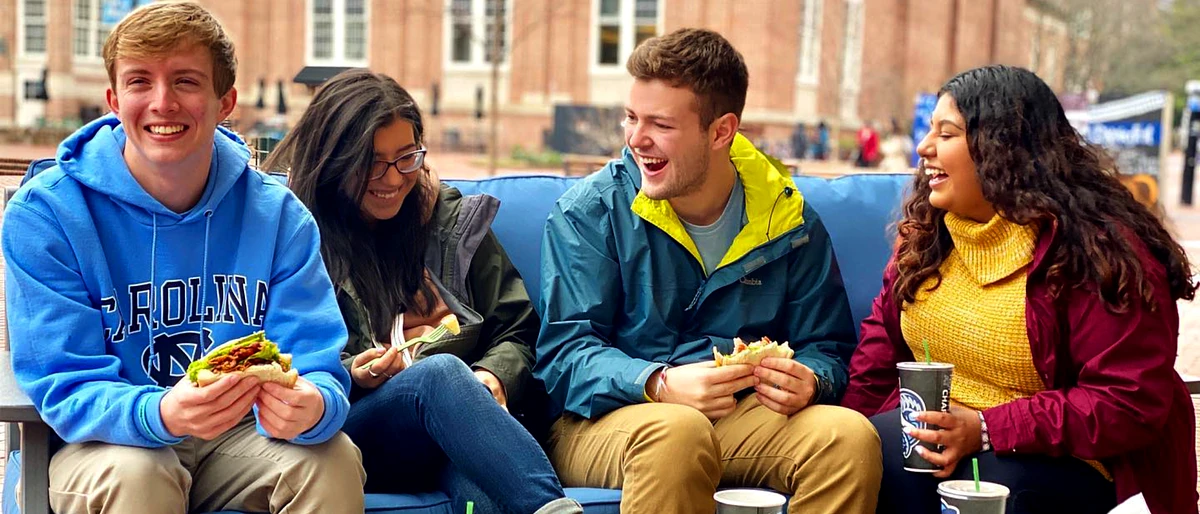 Students eating on-campus and laughing together