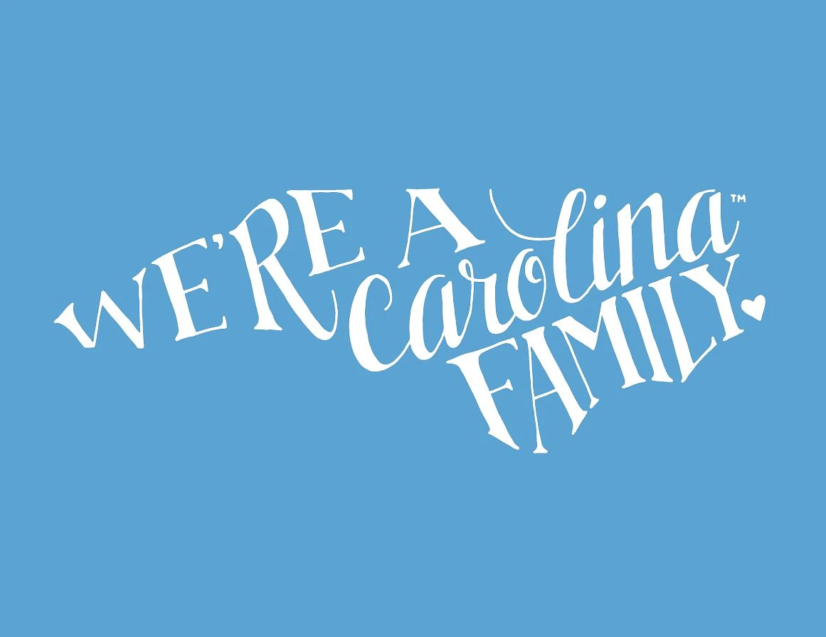 We're a Carolina Family text in the shape of the state of North Carolina